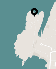 Map with a location pin on a coastal area.