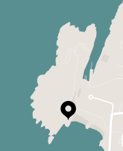 Map illustration with a location pin on a coastal area.
