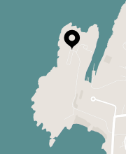 Map graphic with a location pin on a coastal area.