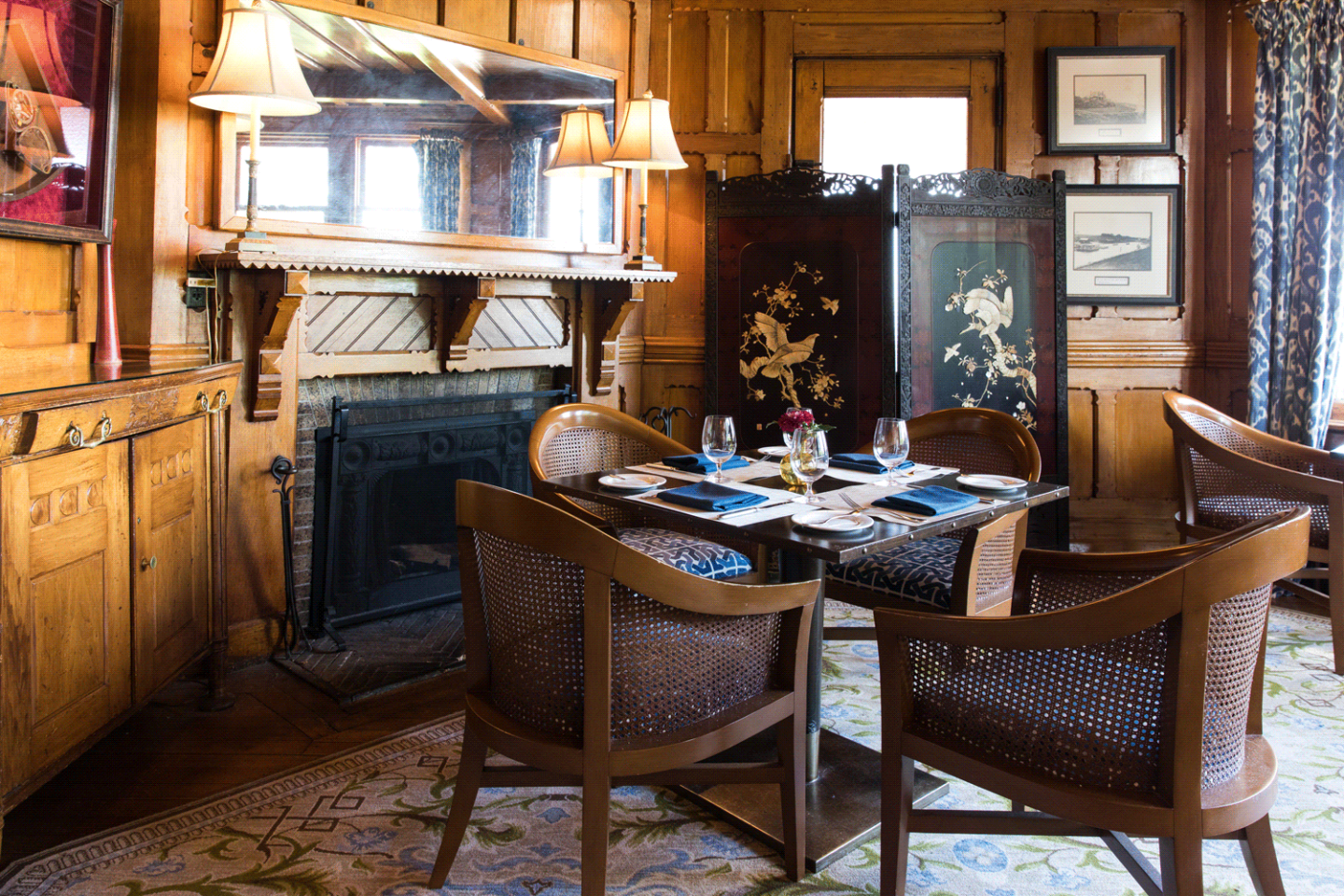 Cozy dining room with wooden decor, a set table, and a decorative screen.