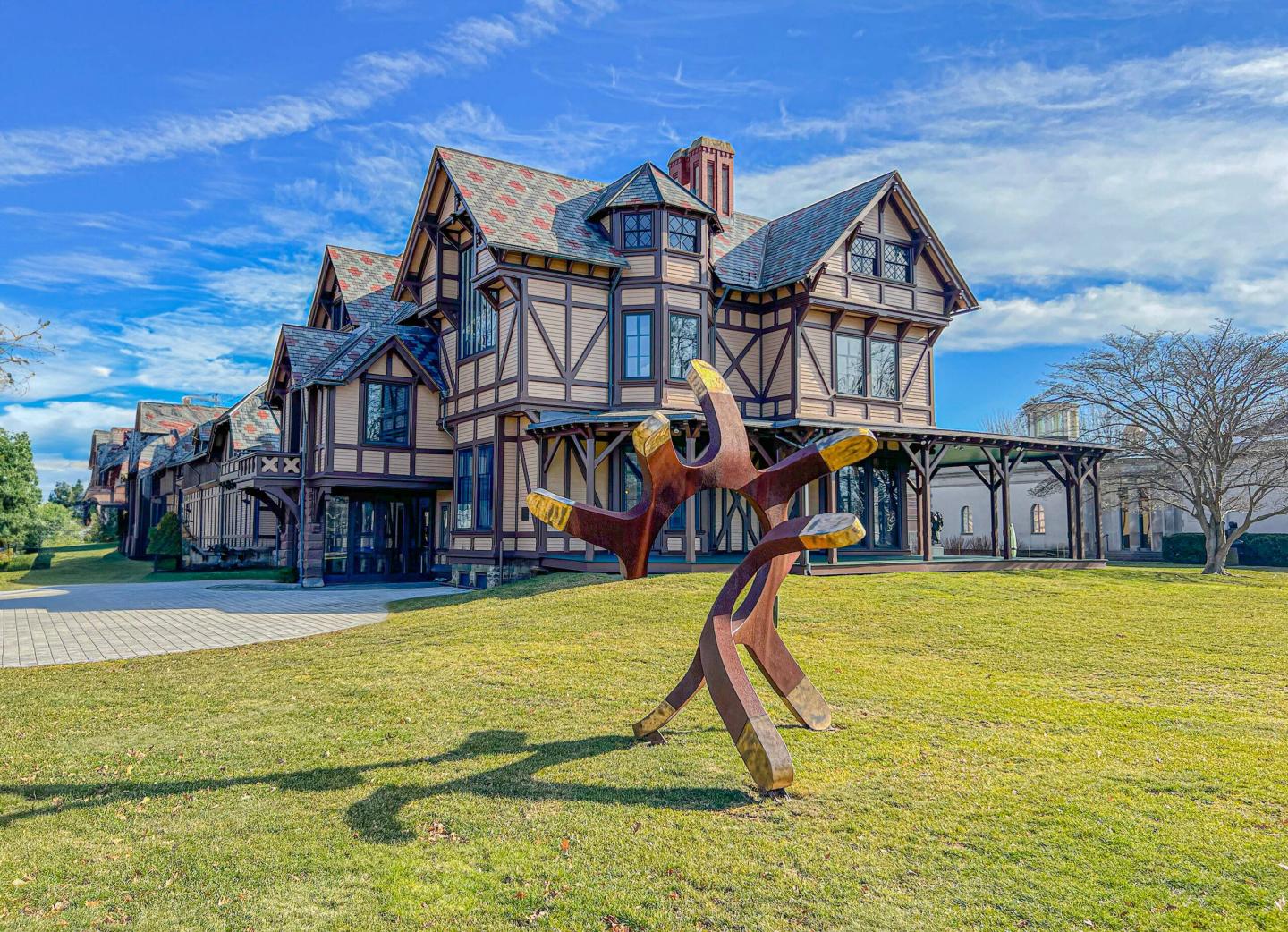 Historic house with decorative sculpture on a sunny day.
