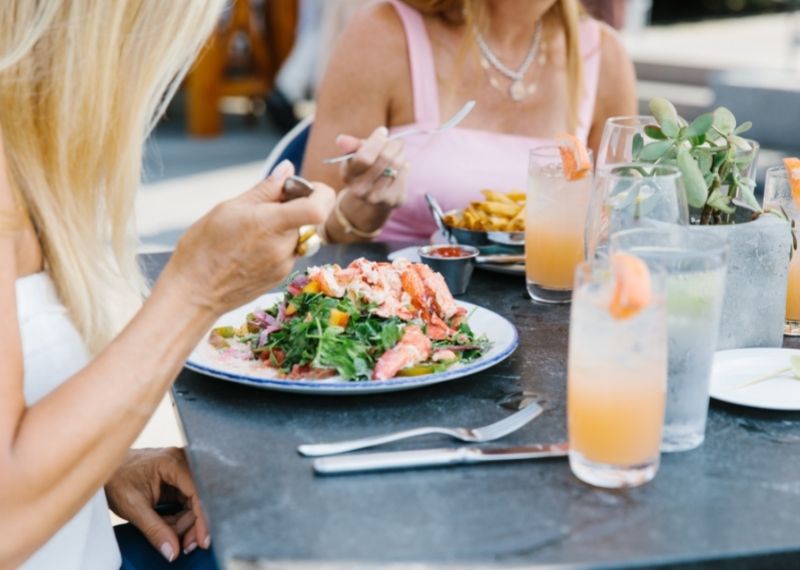 Women at table eating food with frozen drinks at Castle Hill Inn in Newport, RI