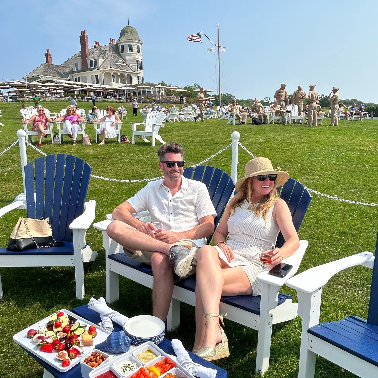 Guest enjoying the Adirondack Chairs on the lawn, Castle Hill Inn in Back ground