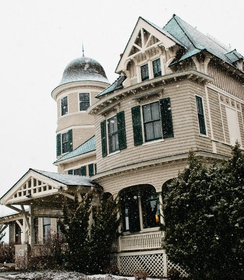Large house exterior at winder with snow falling at Castle Hill Inn in Newport, RI