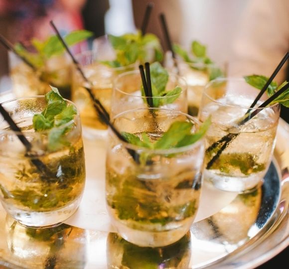 Group of drinks with green garnish on silver tray at Castle Hill Inn in Newport, RI